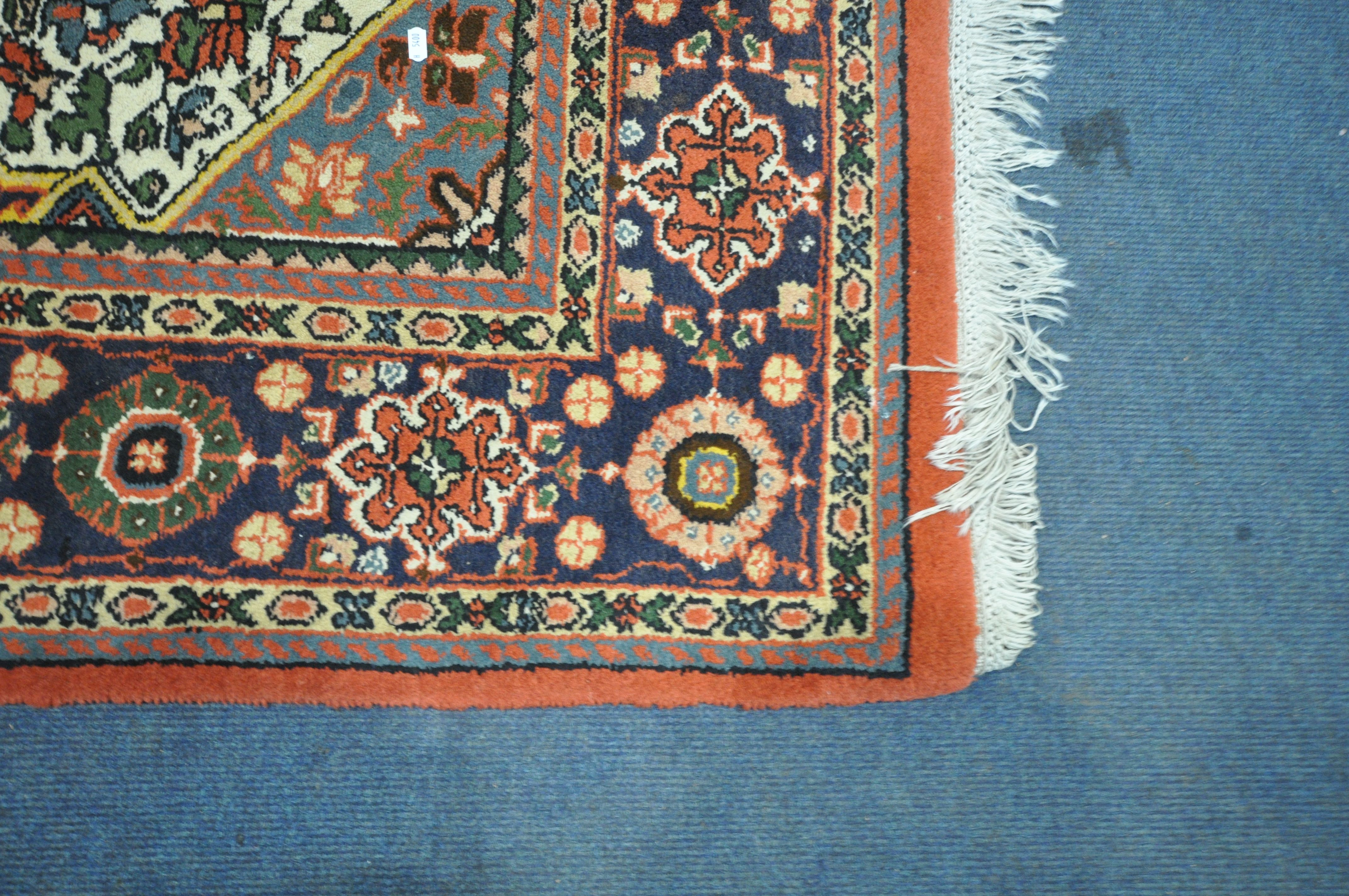 A WOOLMARK RED GROUND RUG, with geometric and floral design, 287cm x 283cm (condition report: - Image 2 of 4