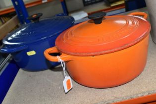 TWO LE CREUSET CASSEROLE DISHES, comprising a Volcanic orange 22cm dish and a deep blue 24cm