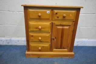 A MODERN PINE CABINET, with five drawers and a single cupboard door, width 71cm x depth 35cm x