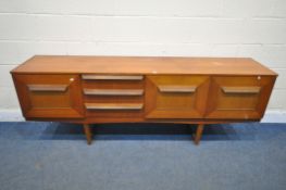 A MID CENTURY TEAK STONEHILL SIDEBOARD, with three drawers and fall front door, flanked by two