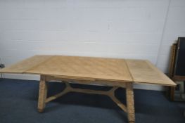 A STRIPPED OAK FRENCH DRAW LEAF BRETON TABLE, with carved geometric legs, united by a cross