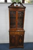 AN EDWARDIAN WALNUT AND INLAID BOOKCASE, the top with two glazed doors, enclosing two shelves, on