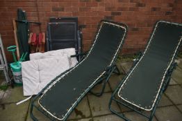 A PAIR OF TUBULAR METAL FOLDING SUN LOUNGERS, along with a pair of metal folding garden armchairs (