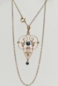 A YELLOW METAL LAVALIER PENDANT NECKLACE, openwork scroll pendant, set with a central blue paste,