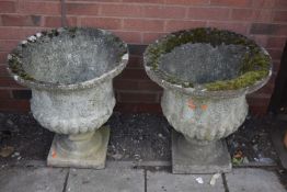 A PAIR OF WEATHERED COMPOSITE CAMPAGNA GARDEN URNS, diameter 58cm x height 61cm (condition report: