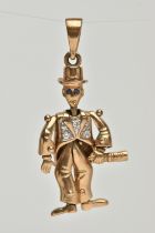 A 9CT GOLD ARTICULATED MAN PENDANT, gentlemen holding a bottle with top hat on, set with blue