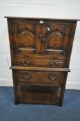 A 20TH CENTURY OAK WINE CABINET, with two doors, a brushing slide and a single drawer, above a