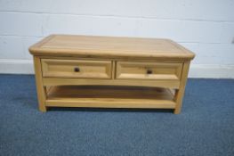 A MODERN SOLID OAK COFFEE TABLE, with two drawers and an undershelf, length 110cm x depth 60cm x