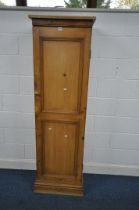 A MODERN PINE CUPBOARD, with a single panelled door, width 56cm depth 36cm x height 186cm (condition