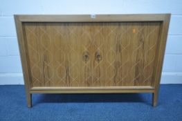A MID-CENTURY GORDON RUSSELL TEAK HELIX SIDEBOARD, the double pattered routed doors enclosing a