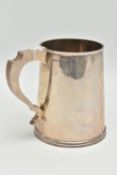 A MID 20TH CENTURY SILVER TANKARD, polished tapered form fitted with a scroll handle, approximate