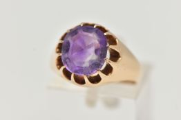 A YELLOW METAL AMETHYST RING, oval cut amethyst, prong set in yellow metal, leading on to a
