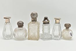 SIX SILVER LIDDED BOTTLES, six glass bottles of varying shapes and size, all fitted with silver