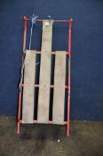A WOODEN SLATTED AND METAL SLEDGE 110cm long (Condition report: some paint losses and surface rust)