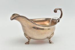A MID 20TH CENTURY SILVER GRAVY BOAT, polished form, gadrooned rim, fitted with a scroll handle,
