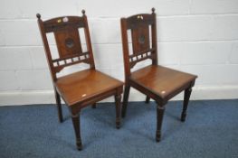 A PAIR OF EDWARDIAN MAHOGANY HALL CHAIRS, with carved detail to backrest, on fluted front legs (