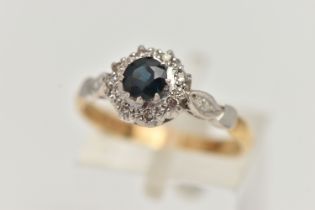 AN 18CT GOLD SAPPHIRE AND DIAMOND CLUSTER RING, designed as a central circular sapphire within a