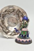 A WHITE METAL DISH AND AN ENAMEL FIGURINE, circular dish decorated with two oriental dragons,