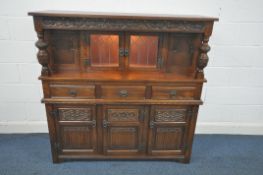 AN OLD CHARM COURT CUPBOARD, with two lead glazed doors, above three drawers and three linenfold