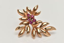 A YELLOW METAL LEAF BROOCH, set with five circular cut rubies, fitted with a brooch pin and safety