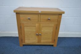 A SMALL SOLID OAK SIDEBOARD, with two drawers over two cupboard doors, length 93cm x depth 43cm x