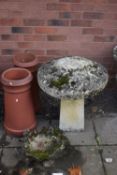 A WEATHERED COMPOSITE STADDLE STONE, on a square tapered base, diameter 57cm x height 63cm, along