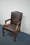A REPRODUCTION GEORGIAN STYLE MAHOGANY GAINSBOROUGH LIBRARY CHAIR, with brown leather upholstery,