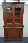 A 19TH CENTURY WALNUT BOOKCASE, the two glazed doors enclosing two adjustable shelves, on a base