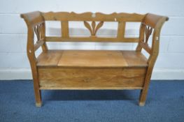 A 19TH CENTURY STYLE PINE HALL SETTLE, with foliate detail to back and sides and a single hinged