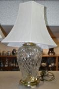 A WATERFORD CRYSTAL 'KILKENNY' PATTERN TABLE LAMP, of shouldered form, having a brass effect