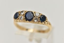 A YELLOW METAL SAPPHIRE AND DIAMOND RING, set with three oval cut deep blue sapphires, interspaced