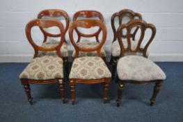 A SET OF FOUR VICTORIAN WALNUT SPOON BACK CHAIRS, with foliate upholstered seat pads, on turned
