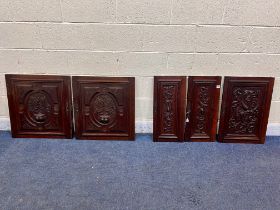 TWO PAIRS OF 20TH CENTURY MAHOGANY PANELED DOORS, and a single door, all with carved foliate detail,