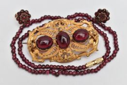 THREE PIECES OF JEWELLERY, to include a large base metal open work brooch set with three oval cut
