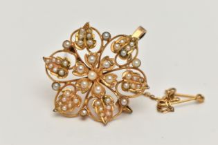 A YELLOW METAL VICTORIAN SEED PEARL BROOCH, open work flower design, set with split and seed pearls,