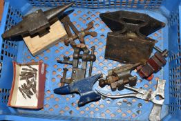 A BOX OF JEWELLERS ANVILS, comprising four cast iron anvils, multi-tool wrench, jewellers hand vice,