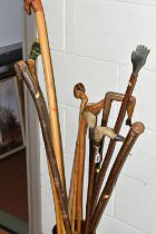 A COLLECTION OF WALKING STICKS, a metal stick stand containing ten assorted walking sticks and a