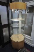 A RIPPLE TALL GLASS OCTAGONAL DISPLAY CABINET, the two opposing doors, enclosing three circular