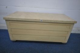 A CREAM PAINTED WOODEN TOOL CHEST, with a hinged lid, on castors, width 113cm x depth 49cm x