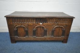 A GEORGIAN OAK COFFER, with a hinged lid, the three front panels with pillar detail, width 131cm x