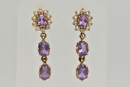 A PAIR OF YELLOW METAL AMETHYST AND SPLIT PEARL EARRINGS, comprised of an oval cut amethyst, prong