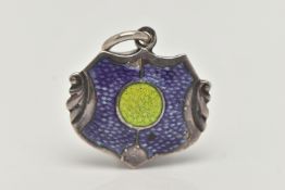 A 'JAMES FENTON' PENDANT, a silver Arts and Crafts shield design pendant with blue and green