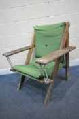 A NORFOLK LEISURE GEORGIANA TEAK FRAMED AND GREEN UPHOLSTERED SWINGING GARDEN CHAIR, with front rope