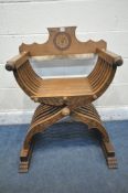 A 20TH CENTURY OAK SAVONAROLA CHAIR, the detachable back rest with floral central crest, X framed
