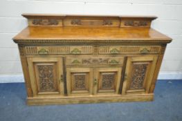 AN EARLY TO MID 20TH CENTURY WALNUT SIDEBOARD, with a raised back, fitted with an arrangement of