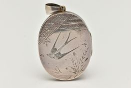 A VICTORIAN WHITE METAL LOCKET, oval form locket, etched with a swallow and foliage design to the