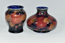 TWO MOORCROFT POTTERY 'POMEGRANATE' PATTERN VASES, each tube-lined with pomegranates, leaves and