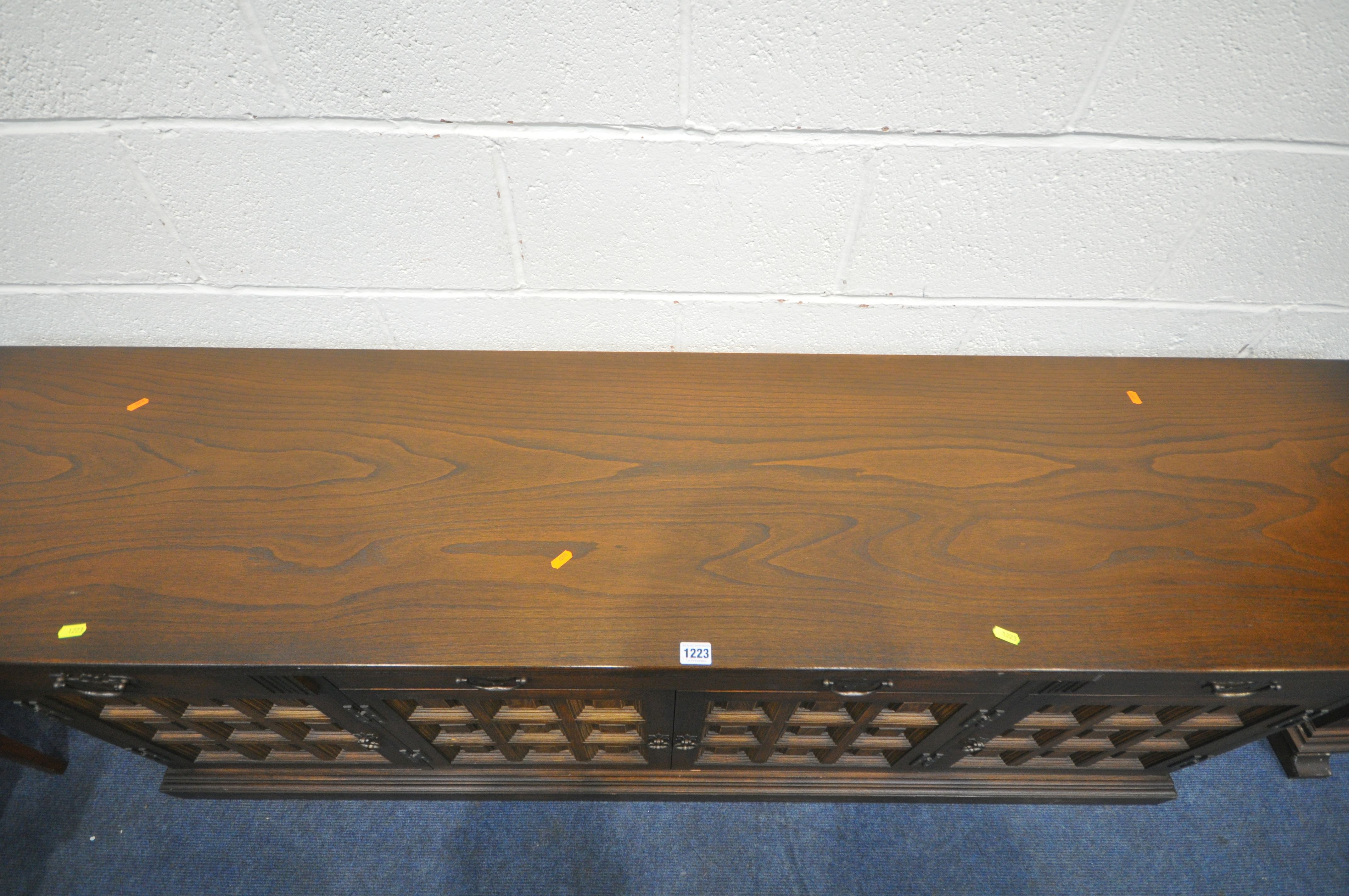 A YOUNGER TOLEDO OAK SIDEBOARD, with three drawers above four cupboard doors, length 207cm x depth - Image 2 of 4