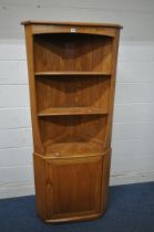 AN ERCOL ELM CORNER CUPBOARD, with two shelves, above a single cupboard door enclosing another