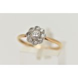 A DIAMOND CLUSTER RING, a principally set round brilliant cut diamond, bezel set in white metal, set